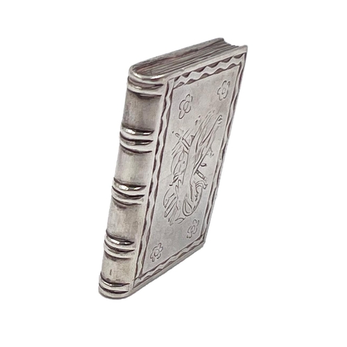 106 - A SILVER BOOK VINAIGRETTE WITH UNUSUAL DECORATION TO FRONT COVER OF MUSICAL INSTRUMENTS, CIRCA 1900A... 