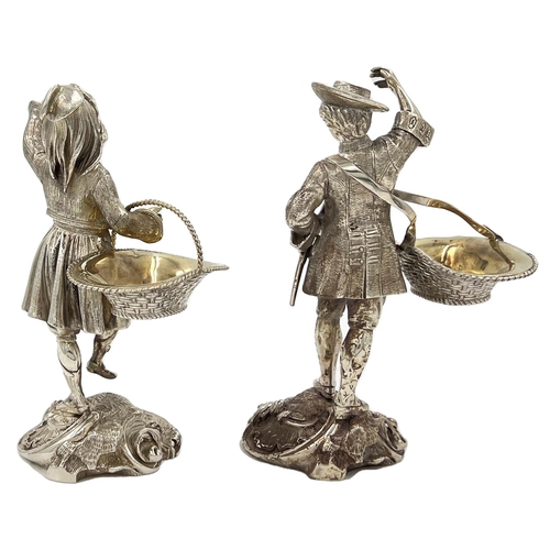 130 - A STUNNING PAIR OF SOILD SILVER FIGURES DEPICTIONG A GENTLEMAN AND A LADY CARRYING BASKETSA stunning... 