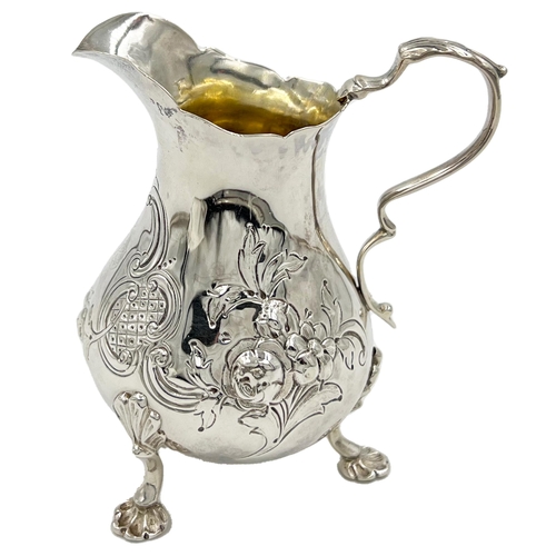 162 - A VICTORIAN SILVER CREAM JUG WITH FLORAL DECORATION, LONDON, ROBERT HARPER, 1865A Victorian silver c... 