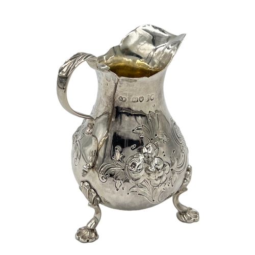 162 - A VICTORIAN SILVER CREAM JUG WITH FLORAL DECORATION, LONDON, ROBERT HARPER, 1865A Victorian silver c... 