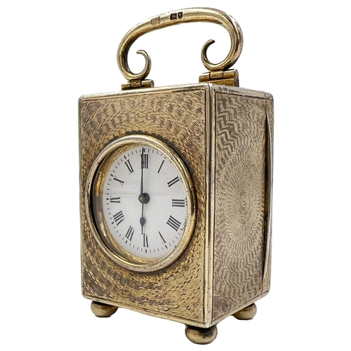 215 - A SMALL SILVER CASED MANTEL/TRAVELLING CLOCK WITH CIRCULAR ENGINE TURNED ENGRAVING, LONDON, 1909A sm... 