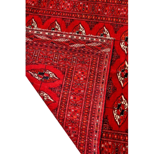 272 - A HAND KNOTTE RED WOOL RUG, UZBEKISTAN, BUKHARAA Hand Knotte Red Wool Rug, Bukhara  H: 177cm, W... 