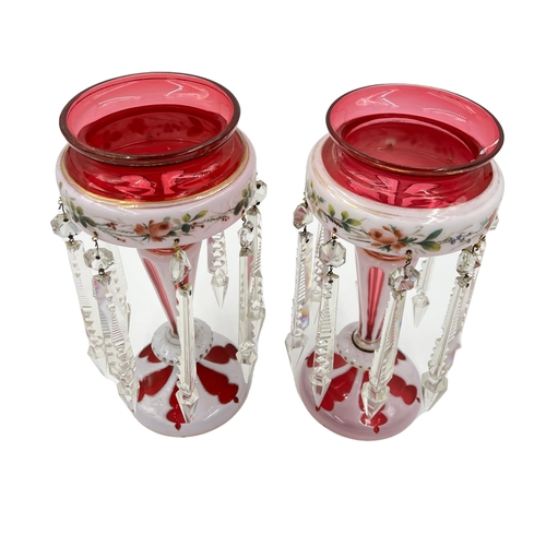 51 - PAIR OF RUBY BOHEMIAN GLASS LUSTRESPair of red Bohemian glass lustres, each measuring 28.5cm. ... 