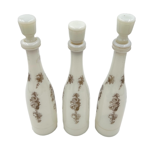 56 - THREE WHITE OPALINE BOTTLES WITH STOPPERSEnhance your collection with this opulent trio of white opa... 