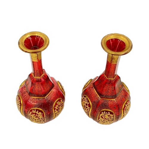 71 - PAIR OF RUBY AND GOLD GILDED BOHEMIAN GLASS VASESPair of Bohemian glass vases features a striking co... 