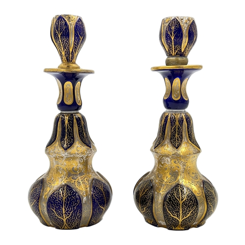 75 - TWO BOHEMIAN GLASS PERFUME BOTTLES WITH BLUE AND GOLD GILDINGA pair of Bohemian glass perfume bottle... 