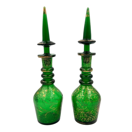 81 - PAIR OF GREEN GLASS DECANTERSA pair of elegant green decanters, each standing 37cm height.... 