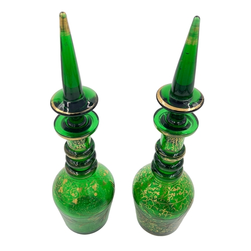 81 - PAIR OF GREEN GLASS DECANTERSA pair of elegant green decanters, each standing 37cm height.... 