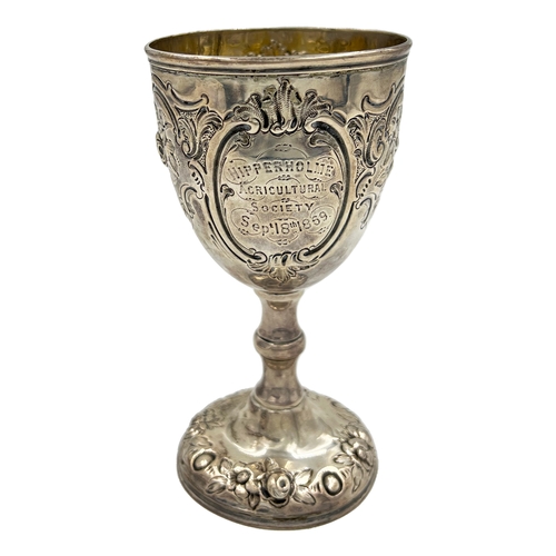 148 - A VICTORIAN SILVER GOBLET WITH EMBOSSED DECORATION AND AN AGRICULTURAL RELATED INSCRIPTION, BH, 1869... 