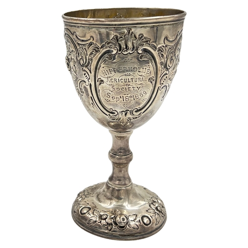 148 - A VICTORIAN SILVER GOBLET WITH EMBOSSED DECORATION AND AN AGRICULTURAL RELATED INSCRIPTION, BH, 1869... 