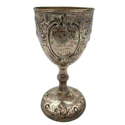 148 - A VICTORIAN SILVER GOBLET WITH EMBOSSED DECORATION AND AN AGRICULTURAL RELATED INSCRIPTION, BH, 1869... 