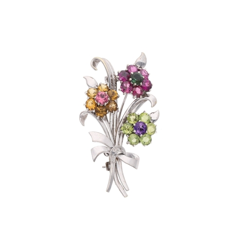 50 - platinum and 9ct white gold set brooch in the shape of a bouquet of flowers, the brooch features 3 f... 