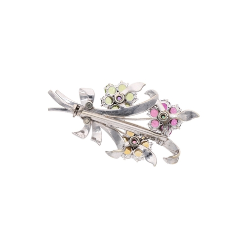 50 - platinum and 9ct white gold set brooch in the shape of a bouquet of flowers, the brooch features 3 f... 