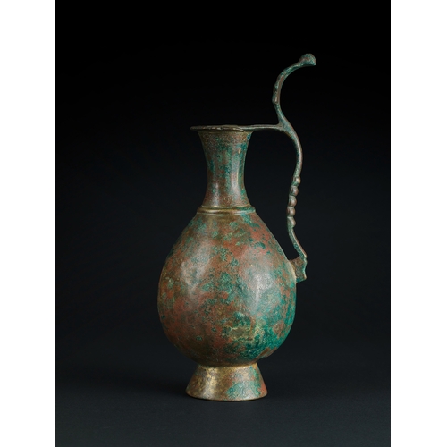 110 - AN UMAYYAD OR EARLY ABBASID BRONZE EWER, PERSIA OR MESOPOTAMIA, 8TH/ 9TH CENTURY    of piriform on a... 