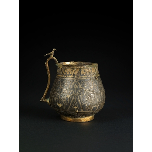 127 - A SILVER-GILT AND NIELLO HANDLED CUP, PERSIA, 11TH/12TH CENTURY    This cup features silver gilding ... 