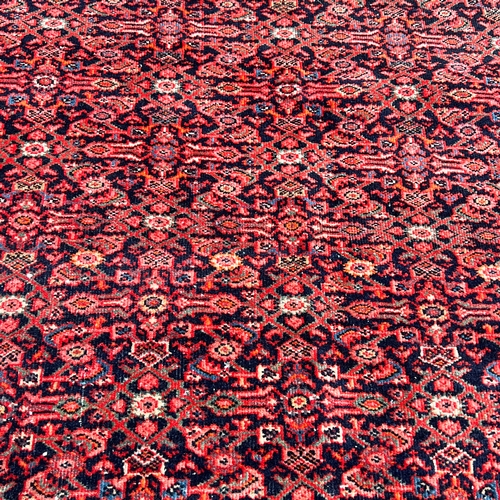 169 - RED PERSIAN WOOL RUG, 20TH CENTURY RED PERSIAN WOOL RUG, 20TH CENTURY     H: 203cm, W: 131.5cm&... 