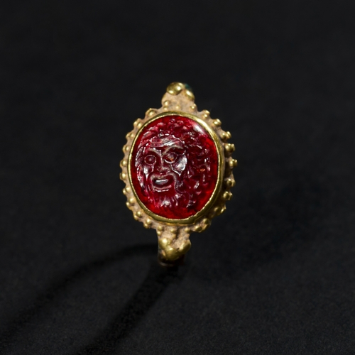 34 - A BRONZE & GOLD SASSANIAN RING WITH ADD ROMAN GARNET INTAGLIO, 3RD CENTURY A unique combination of b... 