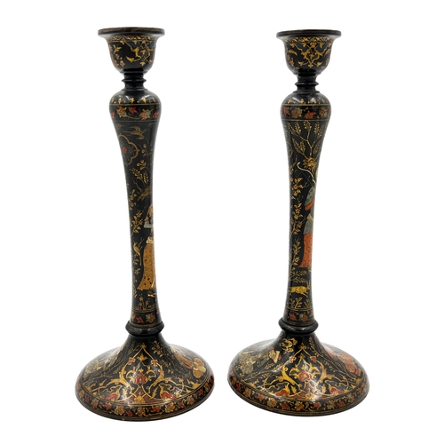 206 - A PAIR OF PERSIAN CANDLE HOLDERS, POSSIBLY QAJAR ERA A pair of Persian candle holders attributed to ... 