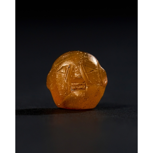 10 - ANCIENT AGATE BEAD PROBABLY THE FORM OF A MAN HEAD, IN THE STYLE OF MID FIRST MILLENNIUM B.C. An anc... 