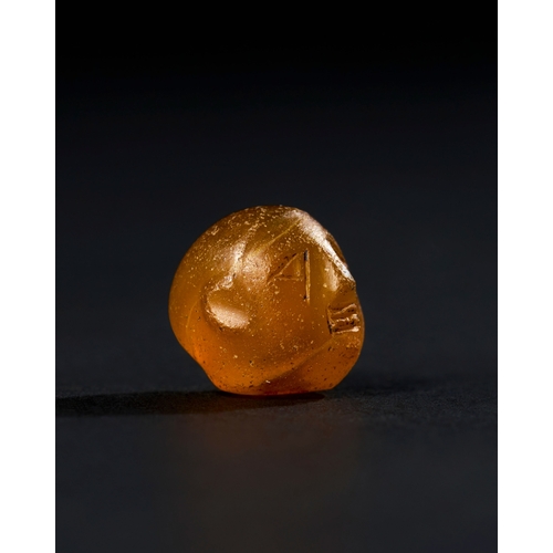 10 - ANCIENT AGATE BEAD PROBABLY THE FORM OF A MAN HEAD, IN THE STYLE OF MID FIRST MILLENNIUM B.C. An anc... 