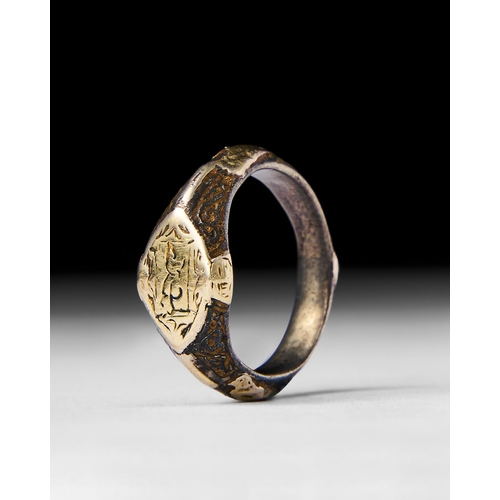 26 - ISLAMIC SILVER AND GOLD INALID RING This Islamic ring featuring a silver band with intricate gold in... 