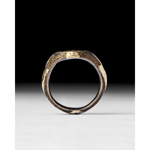 26 - ISLAMIC SILVER AND GOLD INALID RING This Islamic ring featuring a silver band with intricate gold in... 