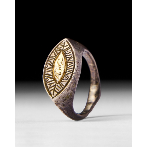 27 - ISLAMIC SILVER RING WITH GOLD CALLIGRAPHY This Islamic ring is crafted from silver and features an e... 