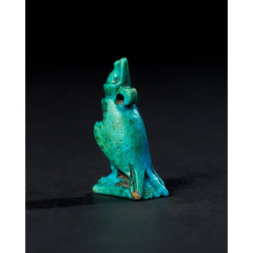 7 - EGYPTIAN BLUE GALZED HORUS AMULET, CIRCA 1300 - 700 B.C. A vibrant blue-glazed amulet represents the... 