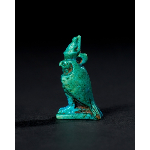 7 - EGYPTIAN BLUE GALZED HORUS AMULET, CIRCA 1300 - 700 B.C. A vibrant blue-glazed amulet represents the... 