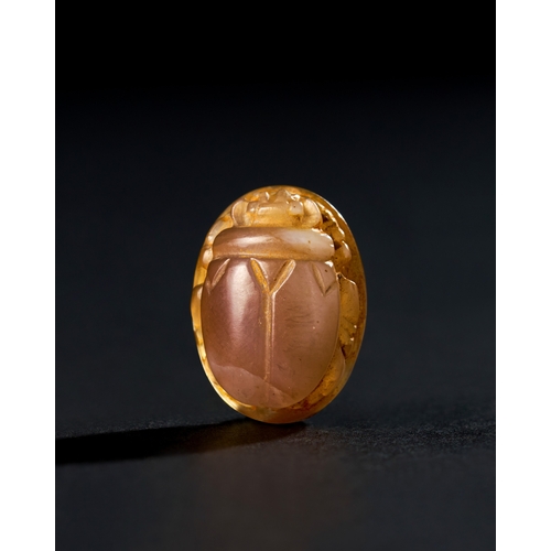 77 - AN EGYPTIAN CHALCEDONY AGATE SCARAB, LATE EGYPTIAN PERIOD AN EGYPTIAN CHALCEDONY AGATE SCARAB, LATE ... 