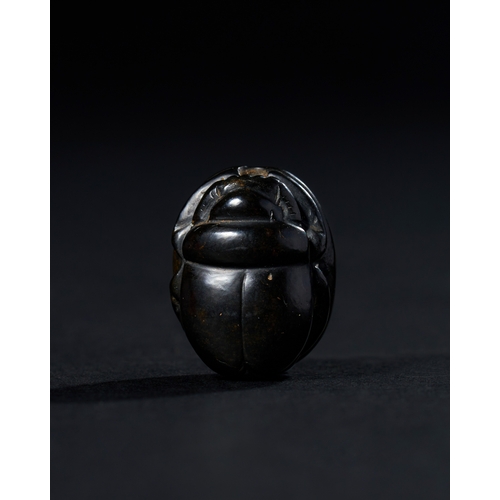 8 - ANCIENT EGYPTIAN BLACK STONE SCARAB, CIRCA 664-30 B.C. A black stone scarab amulet dates back to the... 