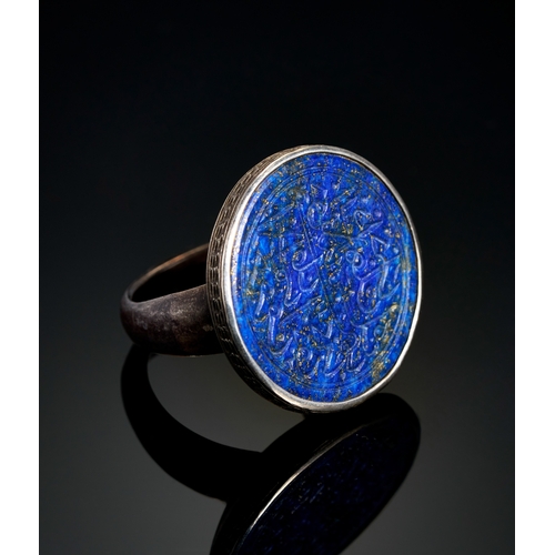 114 - A LARGE ENGRAVED TIMURID LAPIS LAZULI SEAL SILVER RING, 15TH CENTURY  A large engraved Timurid lapis... 