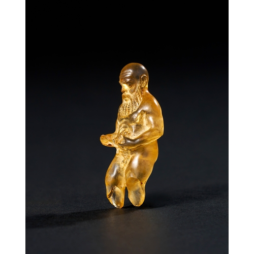 16 - A ROMAN ROCK CRYSTAL FIGURE OF SILENUS HOLDING GRAPES, 2ND CENTURY A.D.  This finely crafted Roman r... 