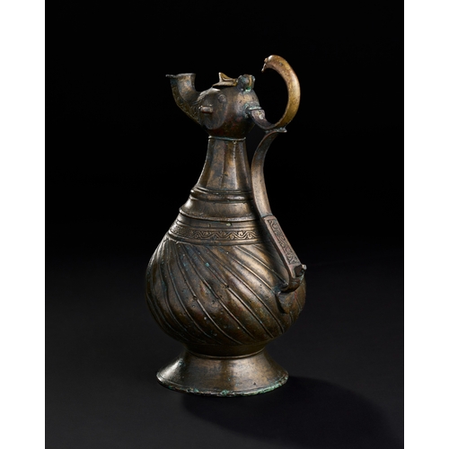 229 - A BRONZE SELJUK EWER, 13TH CENTURY  SELJUK BRONZE EWER, 13TH CENTURY  
 
H: 23.5cm ... 