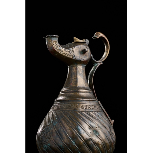 229 - A BRONZE SELJUK EWER, 13TH CENTURY  SELJUK BRONZE EWER, 13TH CENTURY  
 
H: 23.5cm ... 