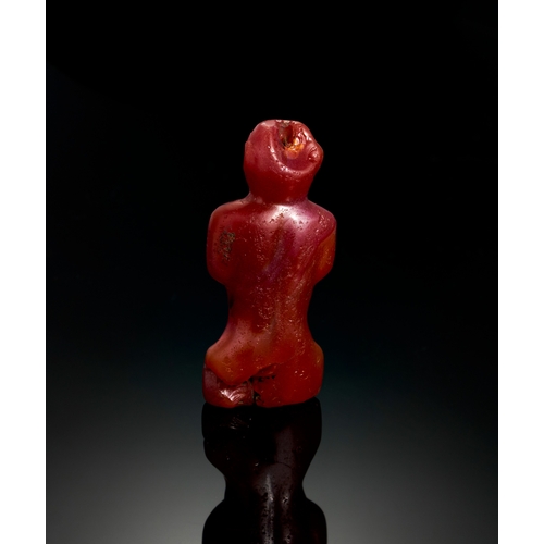 23 - CARNELIAN AGATE FIGURE OF WORSHIPPER OR ATTENDANT, MESOPOTAMIA, LATE 2ND CENTURY MILLENNIUM B.C. TO ... 