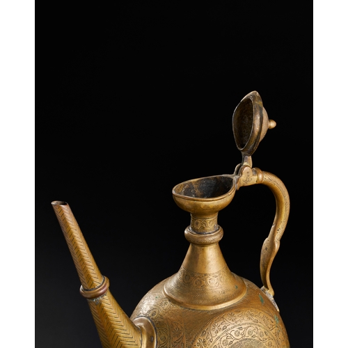 232 - A FINELY ENGRAVED MUGHAL BRASS EWER, NORTH INDIA, LAHORE, 18TH CENTURY A FINELY ENGRAVED MUGHAL BRAS... 