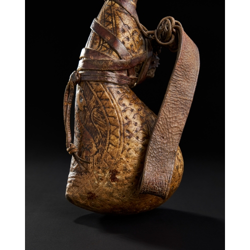 255 - A LARGE SIGNED PERSIAN TOOLED LEATHER WATER FLASK, 18TH CENTURY  A LARGE SIGNED PERSIAN TOOLED LEATH... 