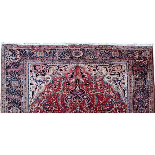 360 - LARGE ANTIQUE HERIZ CARPET, 351 X 250CM  Bold Heriz medallion on a soft red ground with stylish leav... 