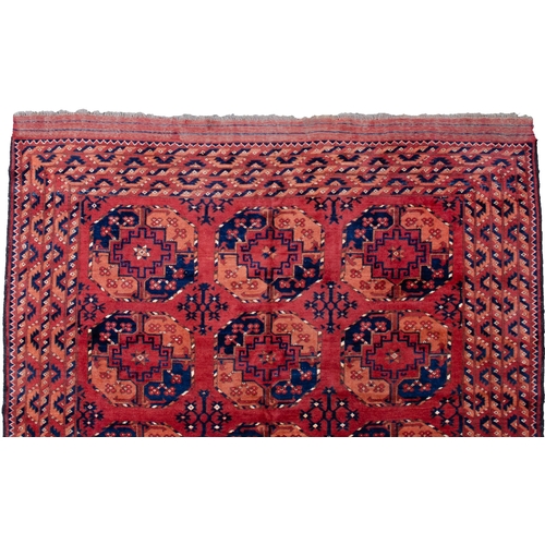 361 - LARGE ANTIQUE ERSARI CARPET, 300 X 198CM Three rows of large octagonal Guls are on a soft red ground... 