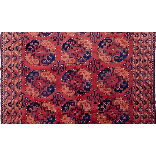 361 - LARGE ANTIQUE ERSARI CARPET, 300 X 198CM Three rows of large octagonal Guls are on a soft red ground... 