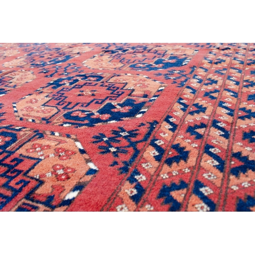 361 - LARGE ANTIQUE ERSARI CARPET, 300 X 198CM Three rows of large octagonal Guls are on a soft red ground... 