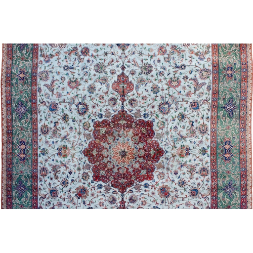 367 - A VINTAGE PART SILK TABRIZ CARPET, 390 X 288CM  A pistachio green ground is decorated with a medalli... 