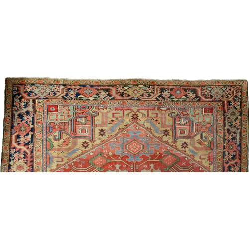 369 - A LARGE ANTIQUE BAKHSHAYSH CARPET, 380 X 294CM  With rich red ground colour contains a large red med... 