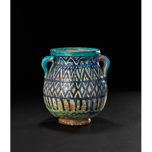 212 - AN OTTOMAN DAMASCUS GLAZED POTTERY TWIN HANDLED VASE, 17TH CENTURYAdorned with a dynamic geometric l... 
