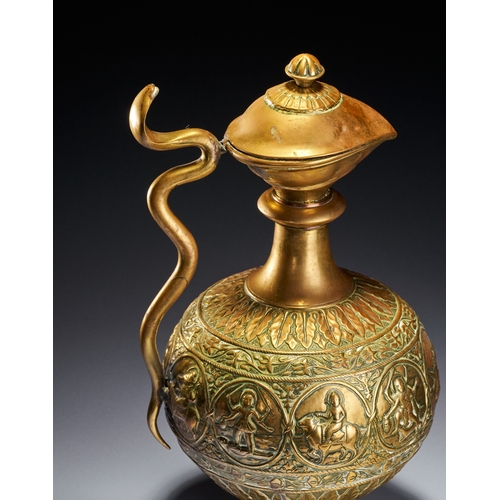 102 - A CHASED BRASS AFTABA EWER WITH SERPENT HANDLE AND HINDU DEITIES, SOUTH INDIA, 19TH CENTURY This Ind... 