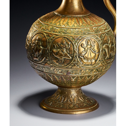 102 - A CHASED BRASS AFTABA EWER WITH SERPENT HANDLE AND HINDU DEITIES, SOUTH INDIA, 19TH CENTURY This Ind... 