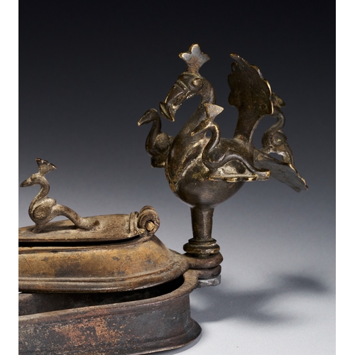 105 - A BRONZE PEACOCK KUMKUM TIKKA SPIRITUAL BOX, DECCAN INDIA, 17TH CENTURY This bronze ritual container... 