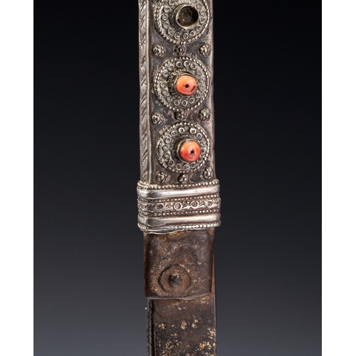 118 - A BEDOUIN SHIBRIYA DAGGER WITH FILIGREE WHITE METAL AND CORAL BEADS, 19TH CENTURY This antique Bedou... 