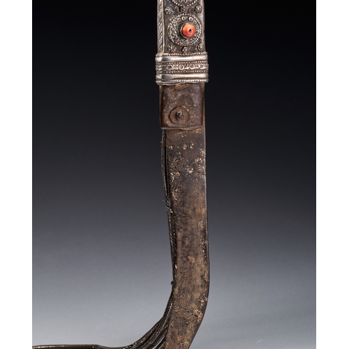 118 - A BEDOUIN SHIBRIYA DAGGER WITH FILIGREE WHITE METAL AND CORAL BEADS, 19TH CENTURY This antique Bedou... 